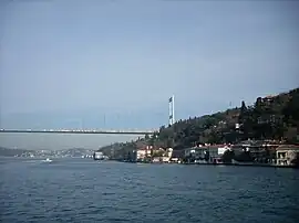 A view of the shores of Anadoluhisarı with Fatih Sultan Mehmet Bridge in the background
