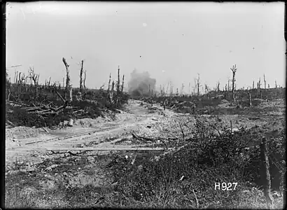 H927. A German shell bursting on road works ahead of the New Zealand Pioneers, Puisieux, France, 21 August 1918. Photo: Henry Armytage Sanders