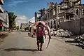 Image 8A man carries a huge hammerhead shark through the streets of Mogadishu