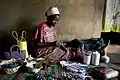 Annette Nandase, a beneficiary of the Beads of Hope Mbuya project, threads beads inside her home in the Mbuya district of Kampala, Uganda on 10 March 2009.