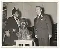 Burke, left, presenting her bust of Samuel Huntington (1938) to the principal of Samuel Huntington Junior High School in Jamaica, Queens