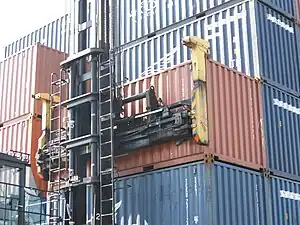 Skystacker attaching to just two top corner castings on one side of 20-foot container