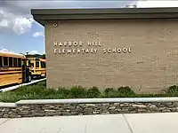 Harbor Hill Elementary School, looking towards the sign with the school's name adjacent to the main entrance plaza