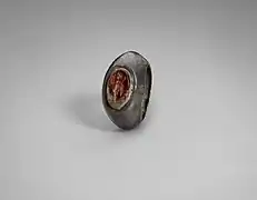 A silver ring set with a carnelian seal carved with a standing figure, circa 100-256 CE