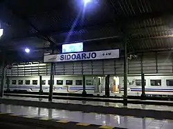 The station platform at night with old version of the signage (2017)