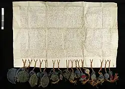 Medieval parchment letter hung with multiple seals.