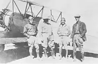 Major Rayma L. Andrews (far right), a Mexican colonel and two pilots wearing goggles during the siege of Naco, Sonora, on April 4, 1929. Both of the pilots were shot down and killed on the following day.
