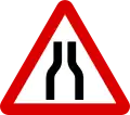 Road narrows on both sides