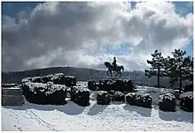 Photo of a statue of Napoleon overlooking a snow-covered scene