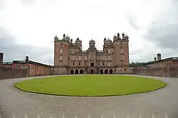 View of the front of Drumlanrig Castle, looking slightly up, and stood right up to the fencing seperating the castle itself from the public