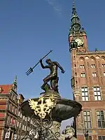 The fountain with the Polish Eagle in the foreground and the Main Town Hall in the background