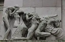 The group to the left of the tomb's entrance. All shield their faces from view. Note the perfect geometric line as their height reduces from the man standing to the far left to the seated woman on the far right.