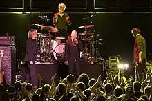 The band onstage smiling