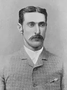 A black and white photo of a man showing his head and shoulders