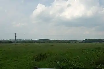 The field to the north of Saint Peter's Church, the site of the domestic buildings of the Priory. There are two large parallel dug out earthworks in the middle of the field which putatively form the remains of a moated convent.