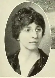 A white woman wearing glasses