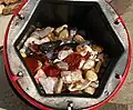 A 6.8 kg (15 lb) barrel full of tumble-polished agate and jasper