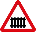 Level crossing ahead, with barrier