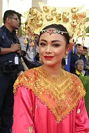 Herman wearing traditional Minangkabau dress, during 2018 Asian Games torch relay on 18 July 2018.