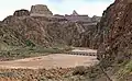 Zoroaster Temple and Sumner Butte (left) seen with footbridge over Colorado River