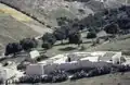 A white farm seen from above with a typical white washed triangular haystack, 1997.